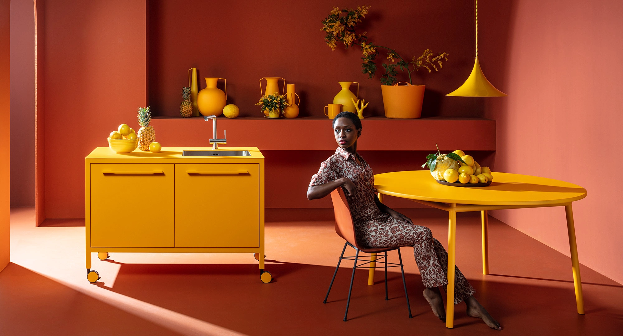 Small metal kitchen on casters in yellow color